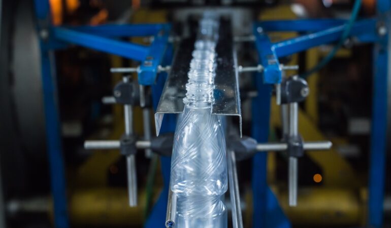 Drink water production line in industry. Bottle filling with water